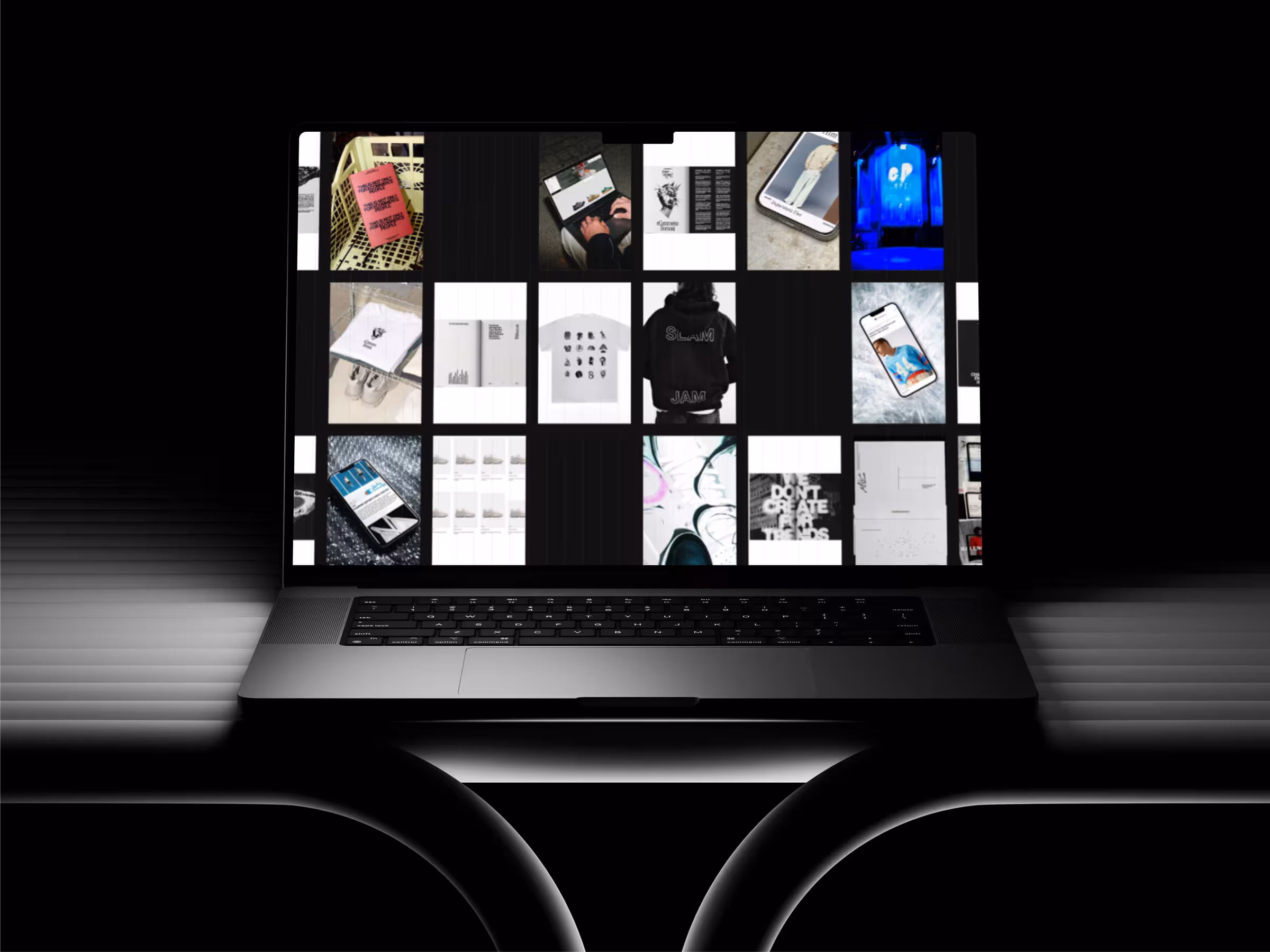 Open laptop displaying a grid of images including clothing, phones, and art on a black background.