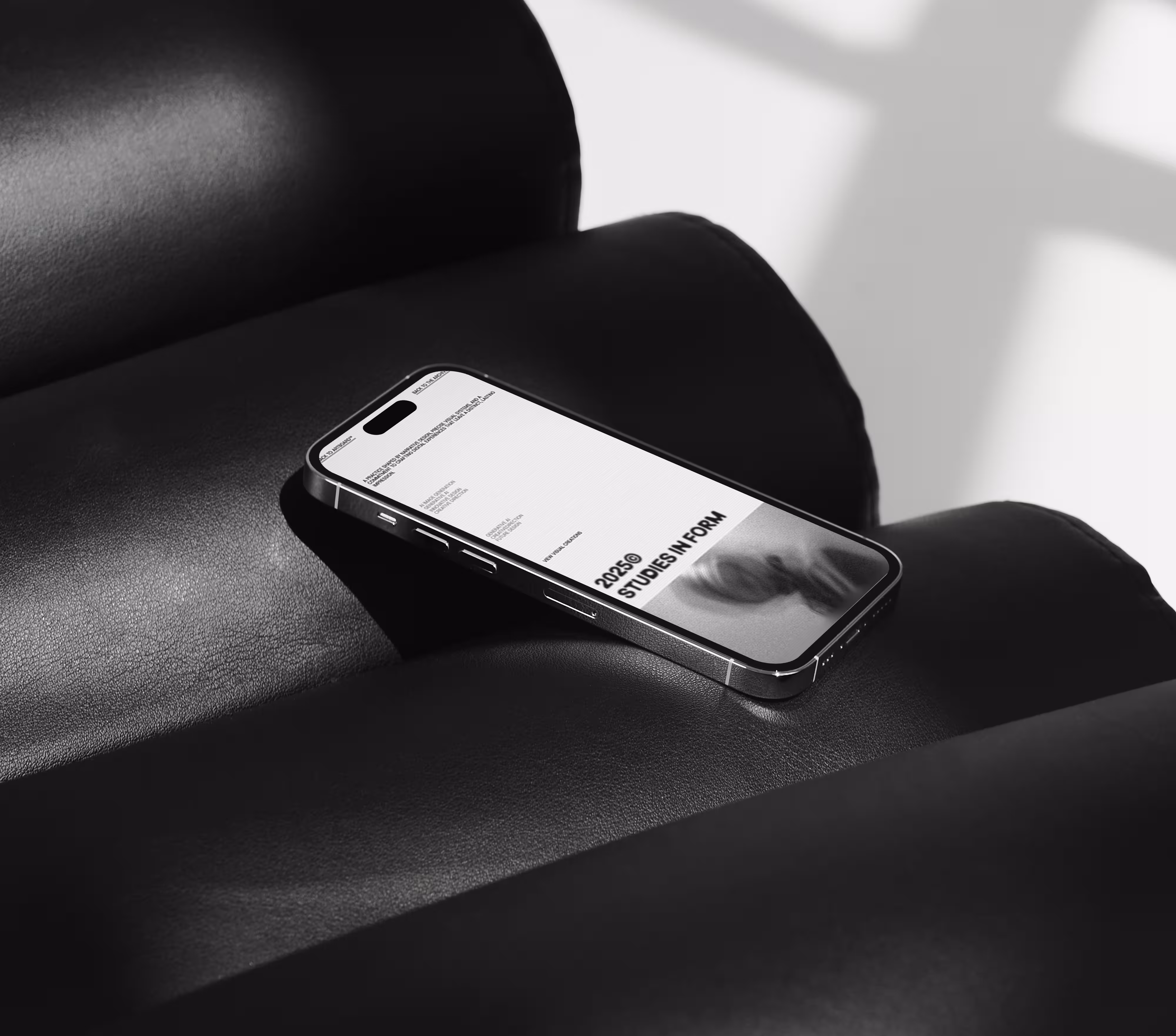 Smartphone displaying 3D model of an earbud on black and orange metallic surface.